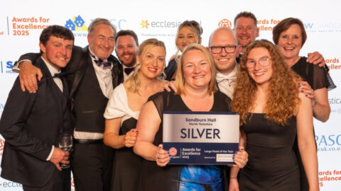 Hayley Abdelsattar, James Hogg, Simon Buckley,, Richard Schroder, Carl Buckton, Beth Lodge, Mark Hudson, Antonia Watkinson, Sarah Balding and Leonora Tognola from Sandburn Hall, Silver winner of the Large Hotel of the Year holding the plaque in front of the logo wall, at the Brighton Dome Corn Exchange, Brighton.