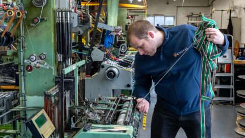 Weaver-Scott-Melvin-works-on-a-narrow-fabric-loom.jpg