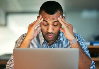 Stressed out. Cropped shot of a young businessman looking stressed while working in the office.