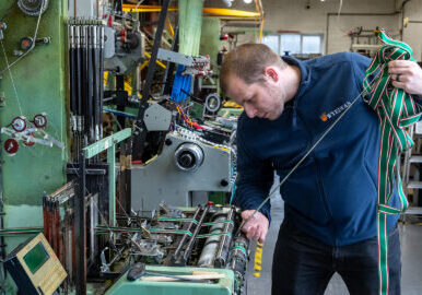 Weaver-Scott-Melvin-works-on-a-narrow-fabric-loom.jpg